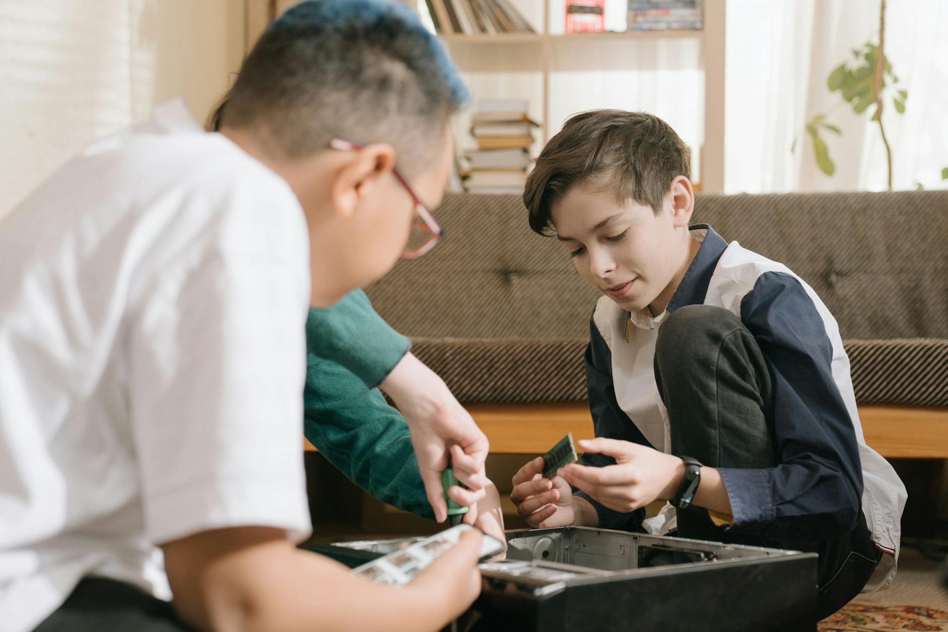 boy in green crew neck t shirt holding black smartphone
