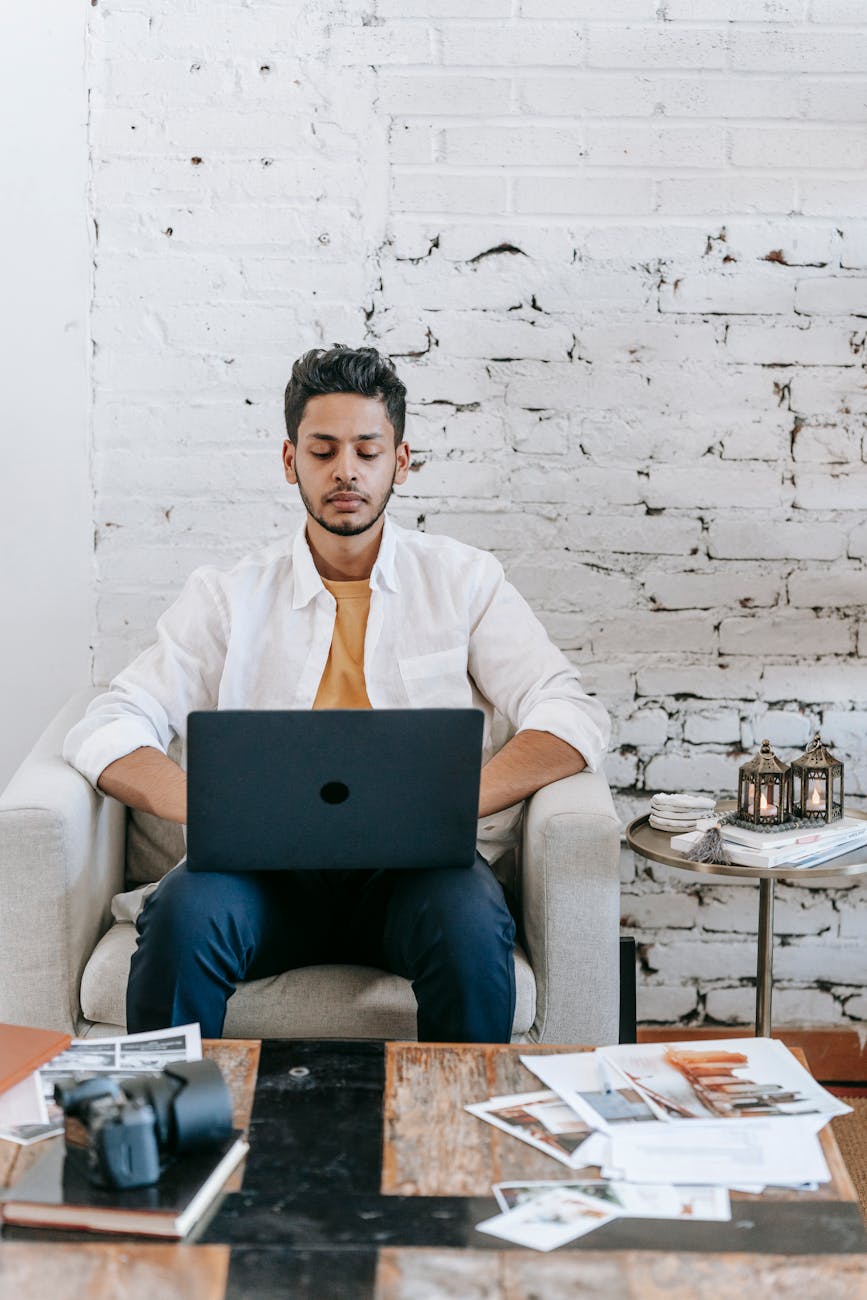 travel blogger using laptop at home