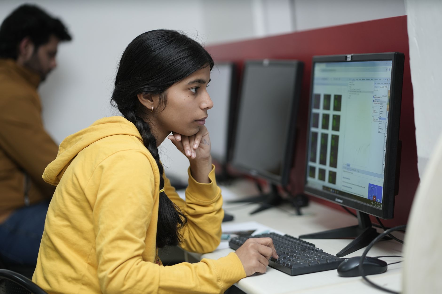 young woman working at computer in office setting