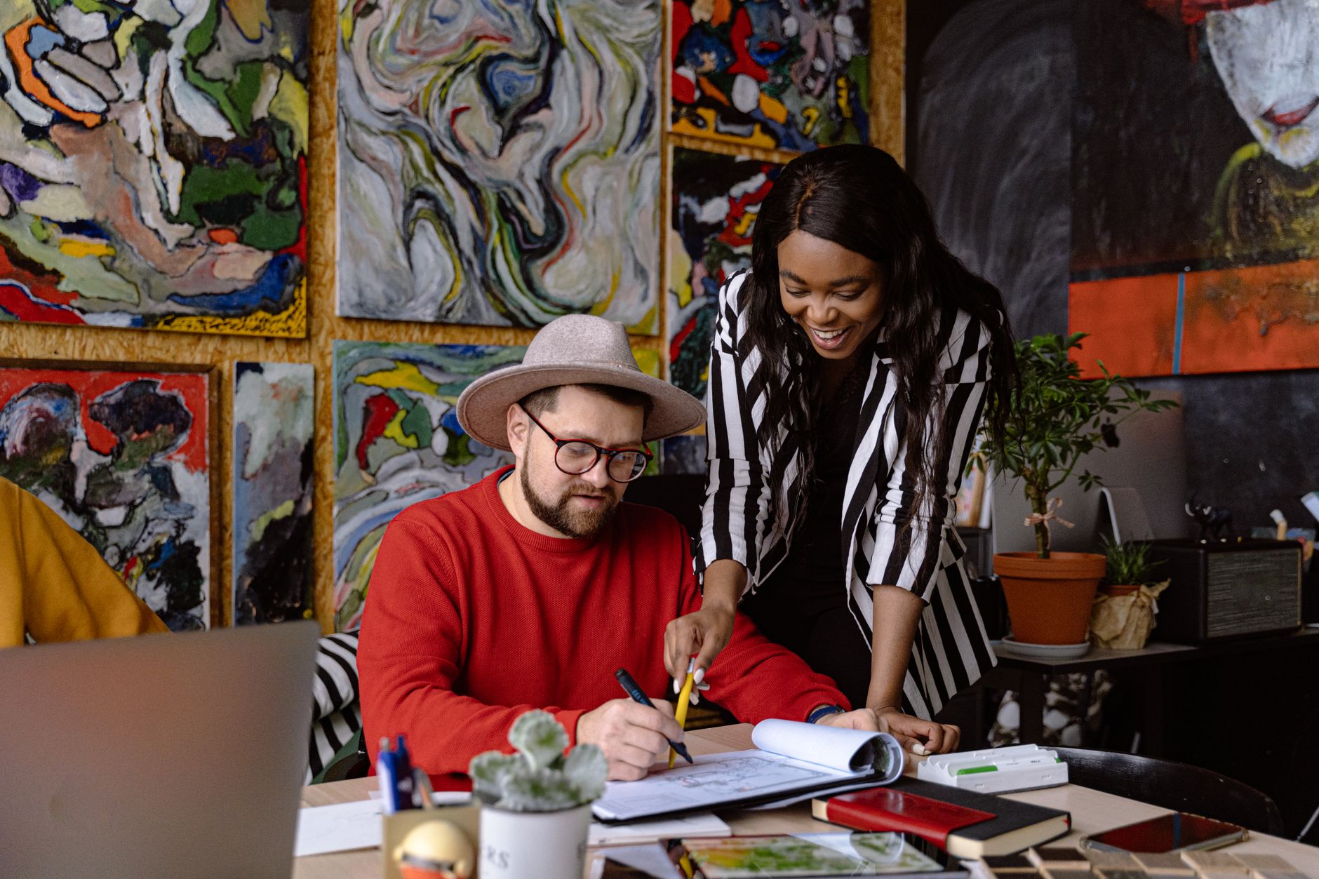 man and woman working together in creative office